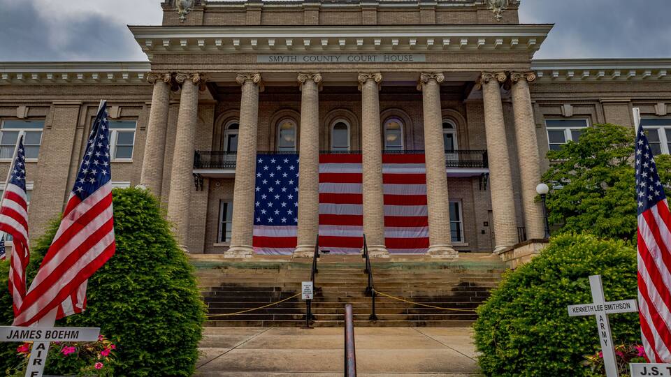 The Smyth County Courthouse with American flags and memorials.