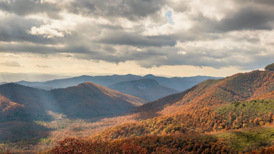 A mountainous landscape with autumn foliage.