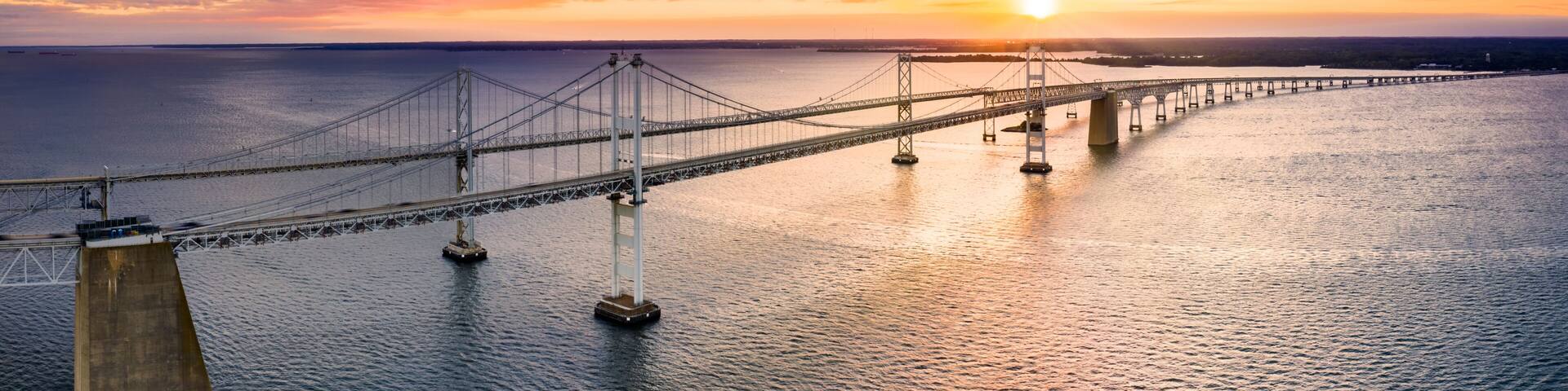 Aerial panorama of Chesapeake Bay Bridge at sunset. The Chesapeake Bay Bridge (known locally as the Bay Bridge) is a major dual-span bridge in the U.S. state of Maryland.