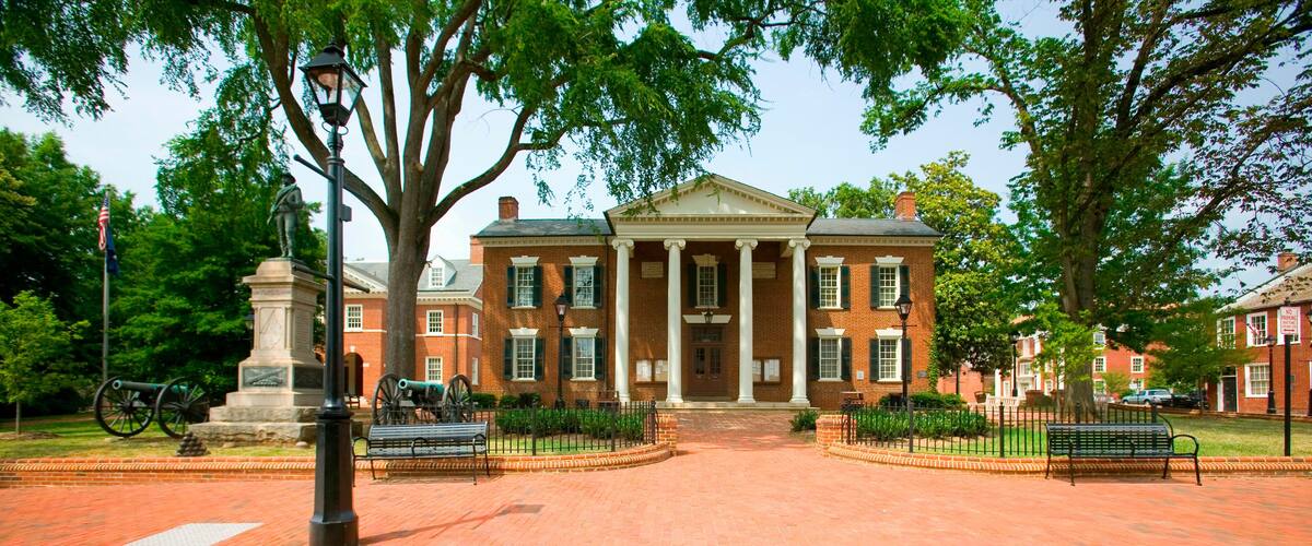 A historic brick building with columns and a central entrance.