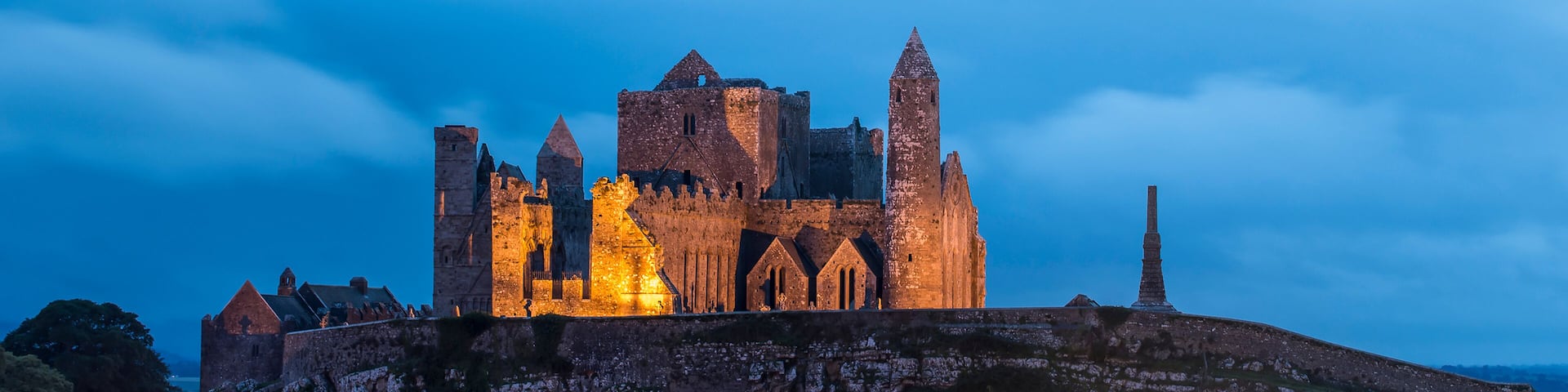The ancient Rock of Cashel illuminated at dusk; Cashel, County Tipperary, Ireland