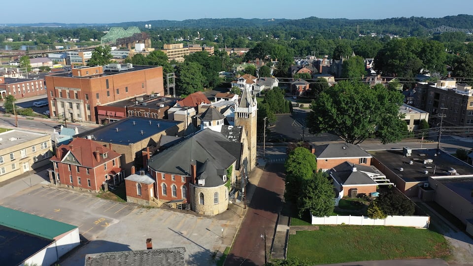 Downtown Parkersburg features a mix of historic buildings and lush greenery under clear skies, highlighting the vibrant character of West Virginias city landscape.