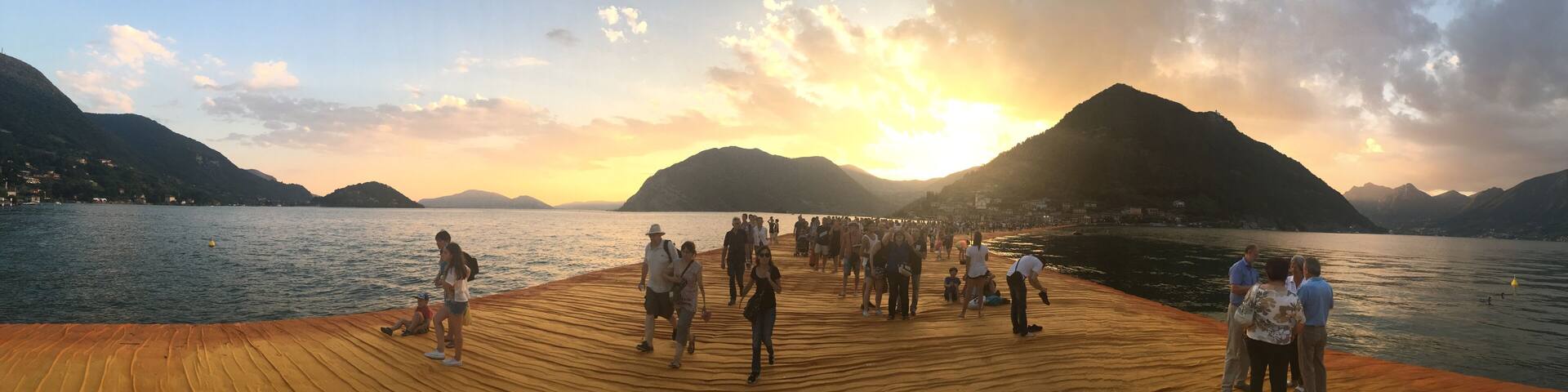 The Floating Piers on Lake Iseo near Sulzano, Italy at sunset.