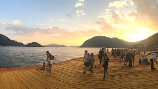 The Floating Piers on Lake Iseo near Sulzano, Italy at sunset.