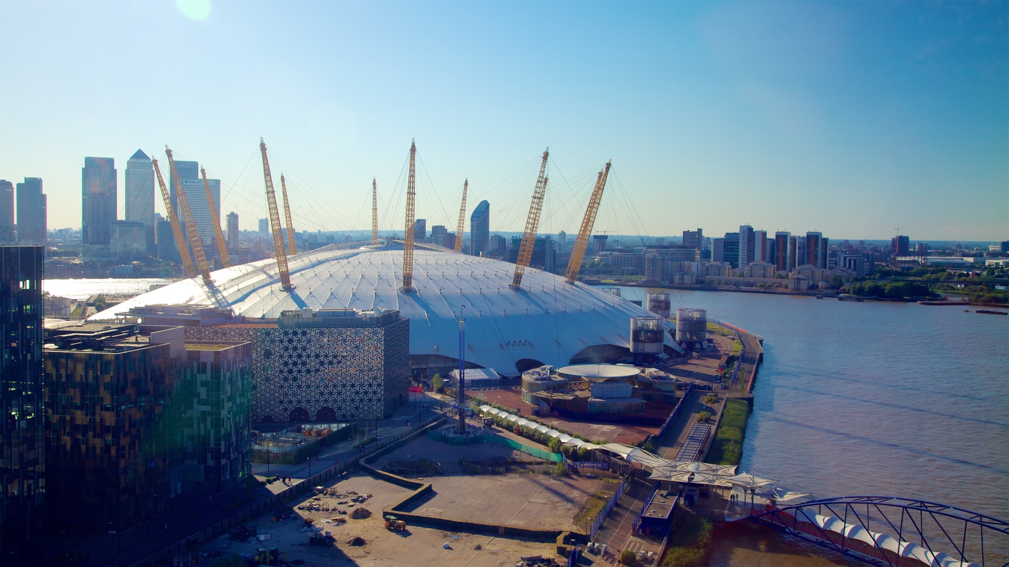 O2 Arena which includes modern architecture, a city and a river or creek