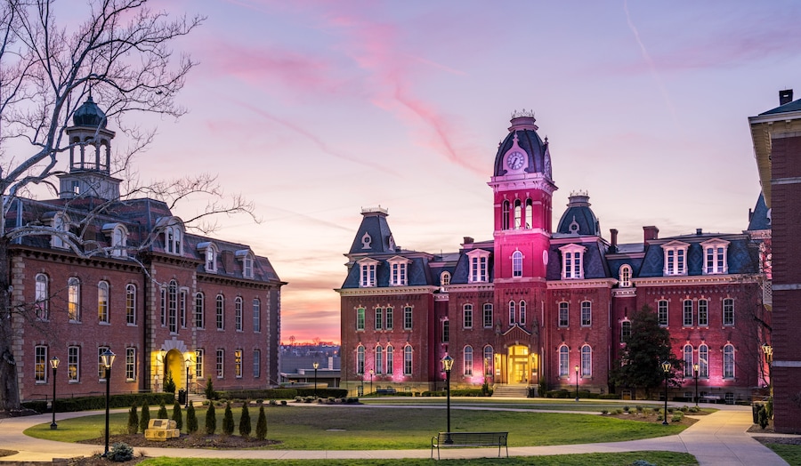 Dramatic image of Woodburn Hall at West Virginia University or WVU in Morgantown WV as the sun sets behind the illuminated historic building