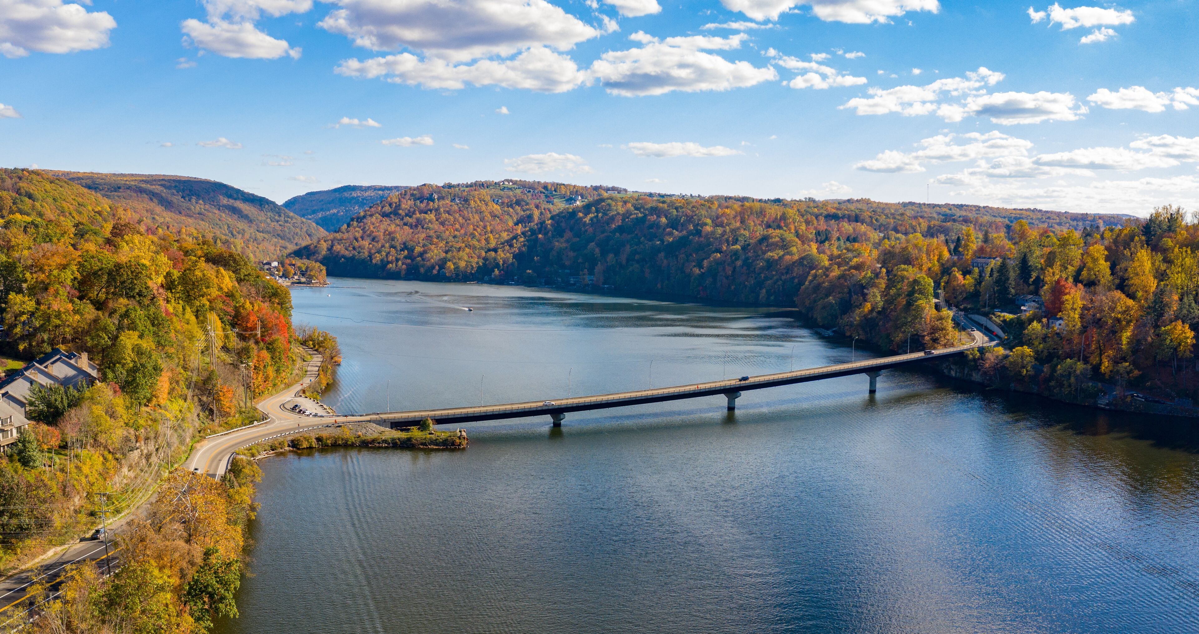 Aerial drone panorama of the autumn fall colors surrounding Cheat Lake and the Old Cheat Road bridge near Morgantown, West Virginia