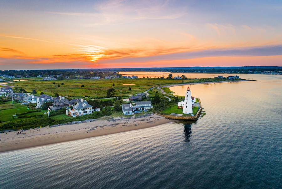 Summer sunset on the Connecticut River, Shoreline, and Long Island Sound in Old Saybrook, CT, with Lynde Lighthouse in the foreground, along with Fenwick, and a colorful summer sunset sky