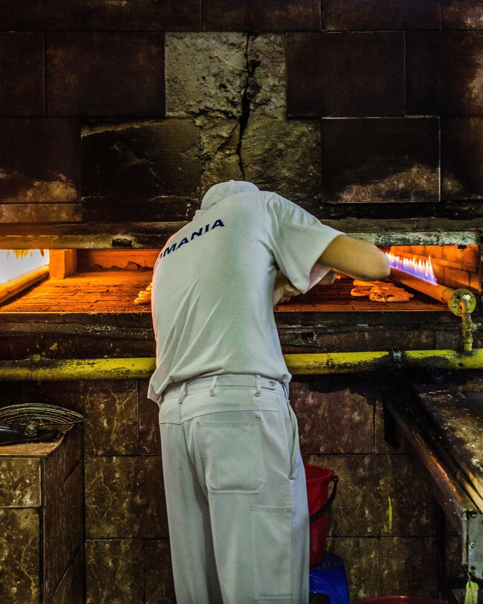 A vendor making soft pretzels at the market. They serve them on a string fresh from the oven. Yummy!! 