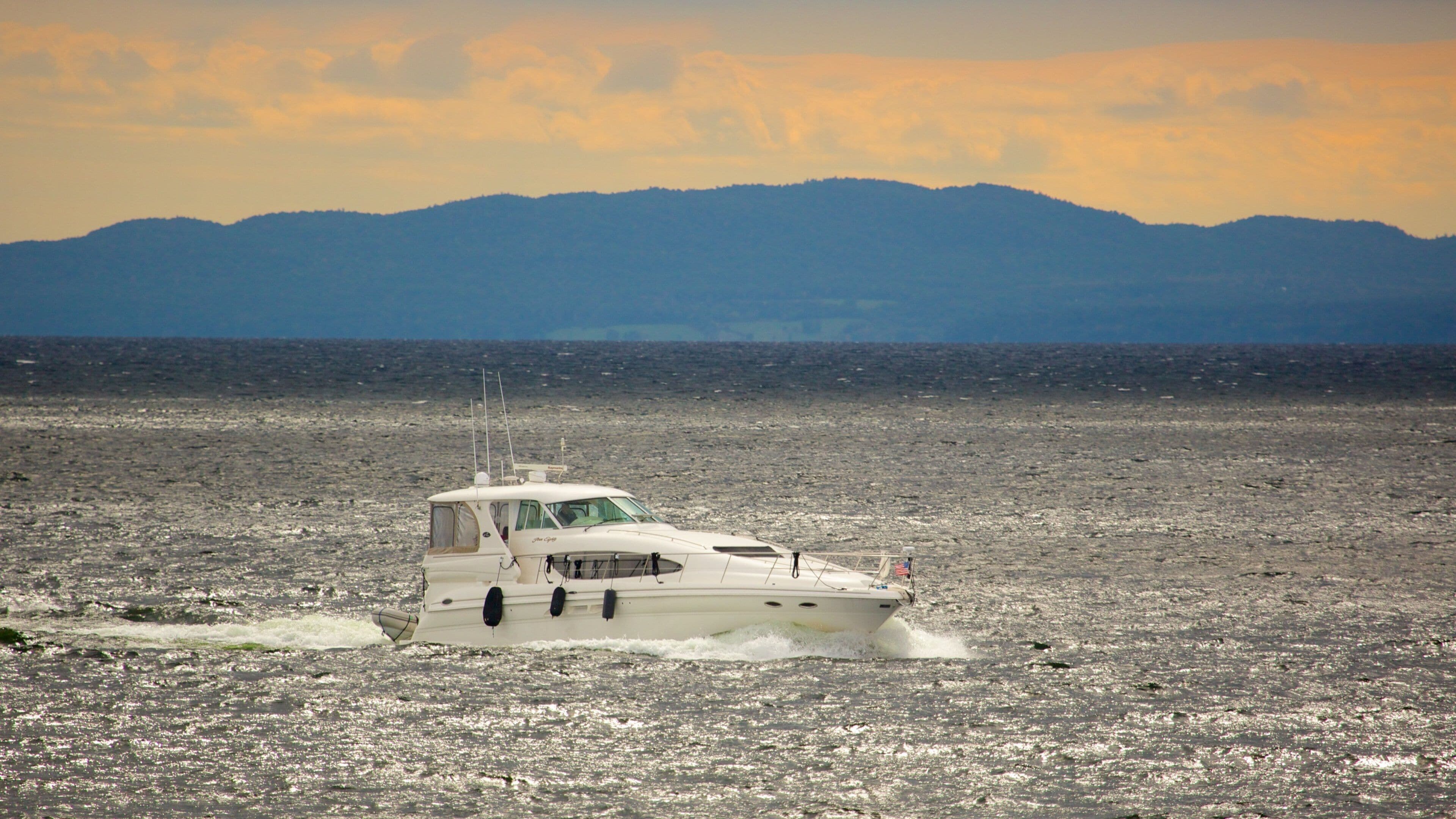 Northern Vermont which includes a sunset, boating and a lake or waterhole