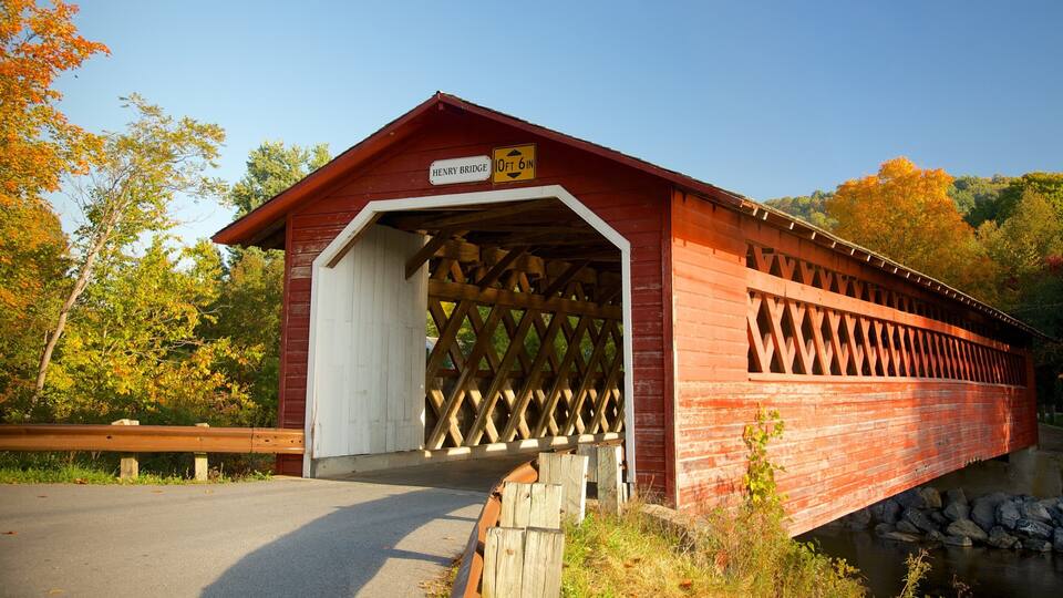 A covered bridge with a sign indicating a height restriction of 10 feet 6 inches.