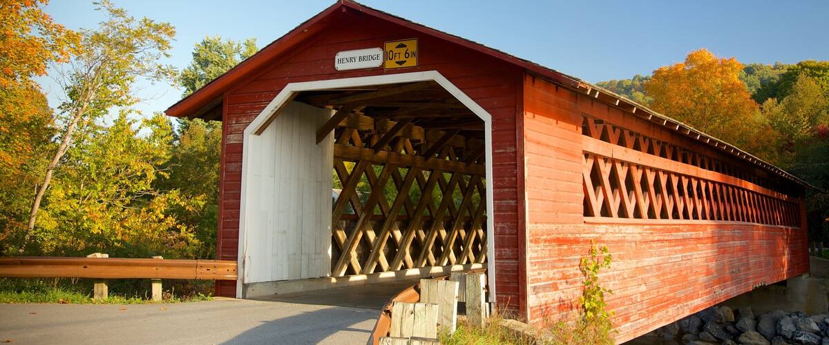 A covered bridge with a sign indicating a height restriction of 10 feet 6 inches.