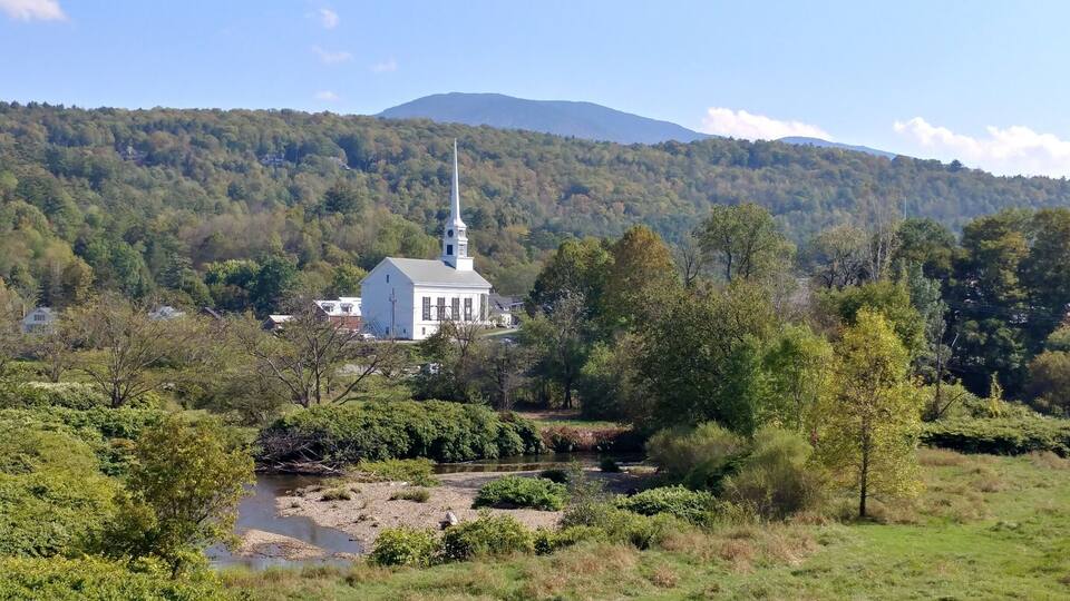 The beautiful Stowe Community Church alone the river in Stowe Vt
