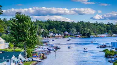 A riverside town with boats, houses, and a dock.