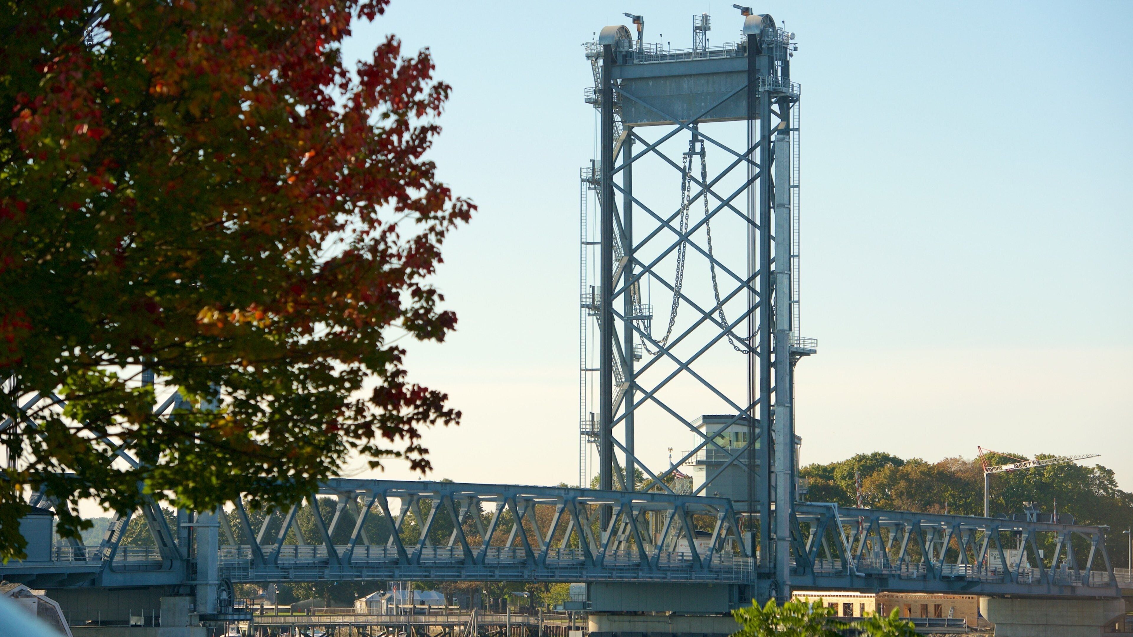 A large steel bridge with a lattice tower and a river beneath.