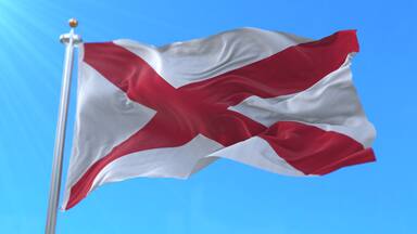 Flag of Alabama state, region of the United States, waving at wind
