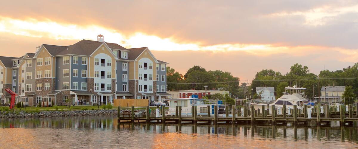 A waterfront residential area with multi-story buildings and docked boats.