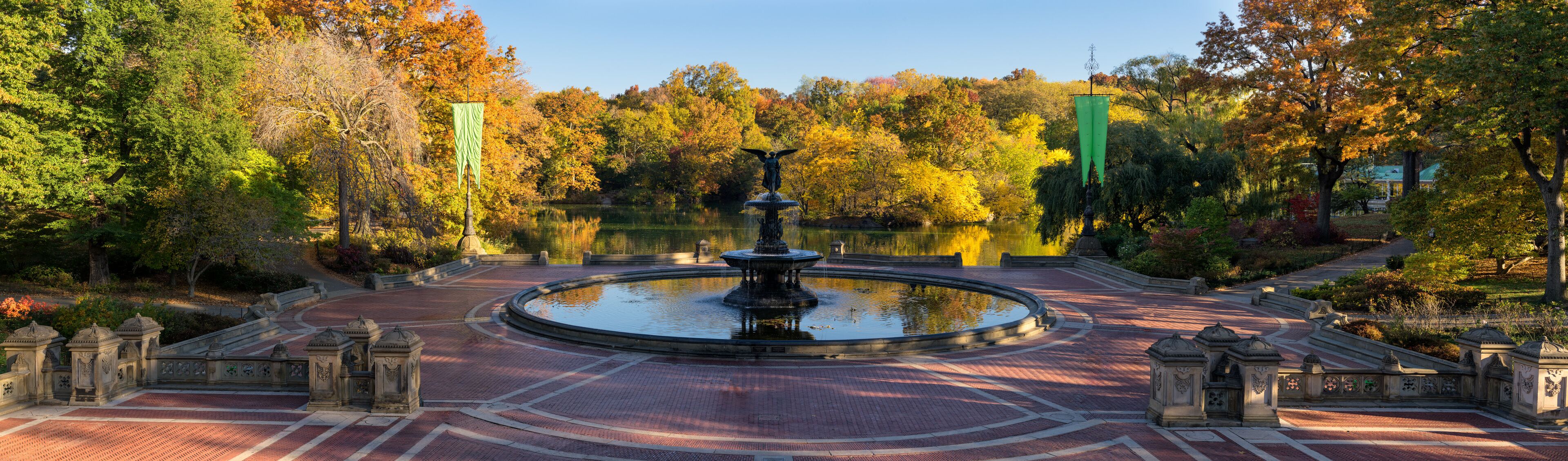 Sunrise in Central Park at Bethesda Fountain with The Lake and colorful Fall foliage. Panoramic view of the Bethesda Terrace, Manhattan, New York City