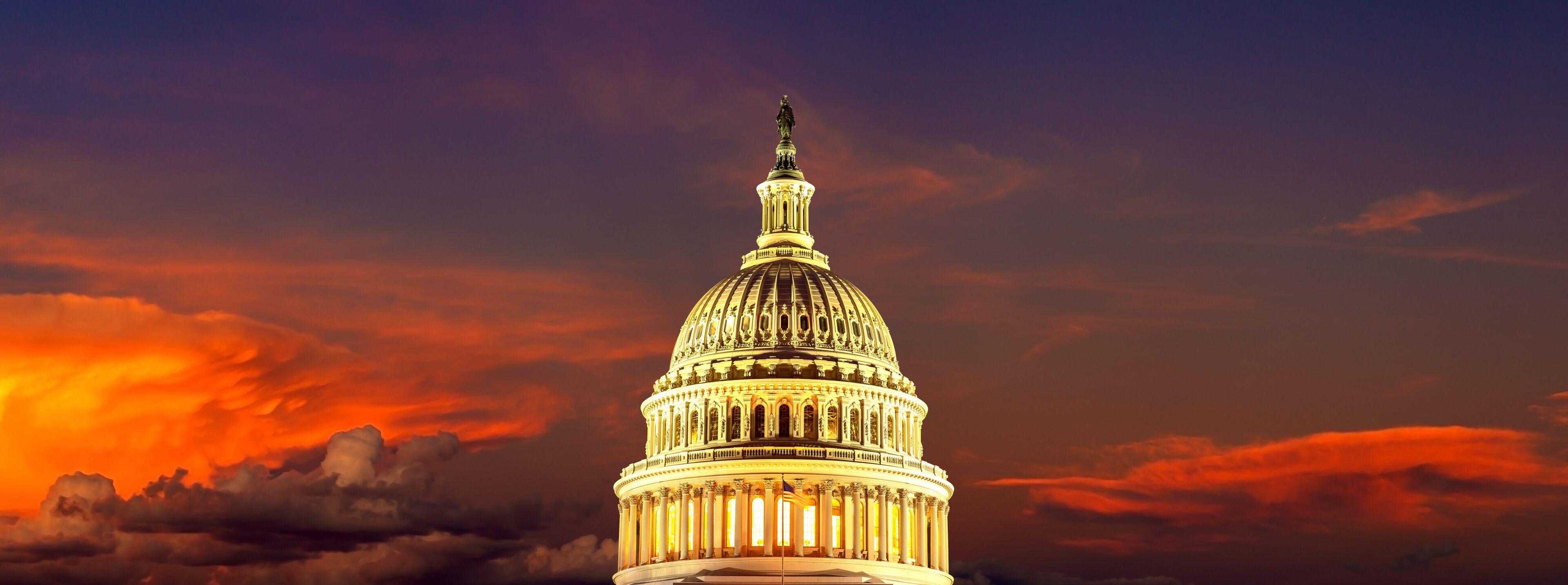 The United States Capitol building at sunset with a dramatic sky.