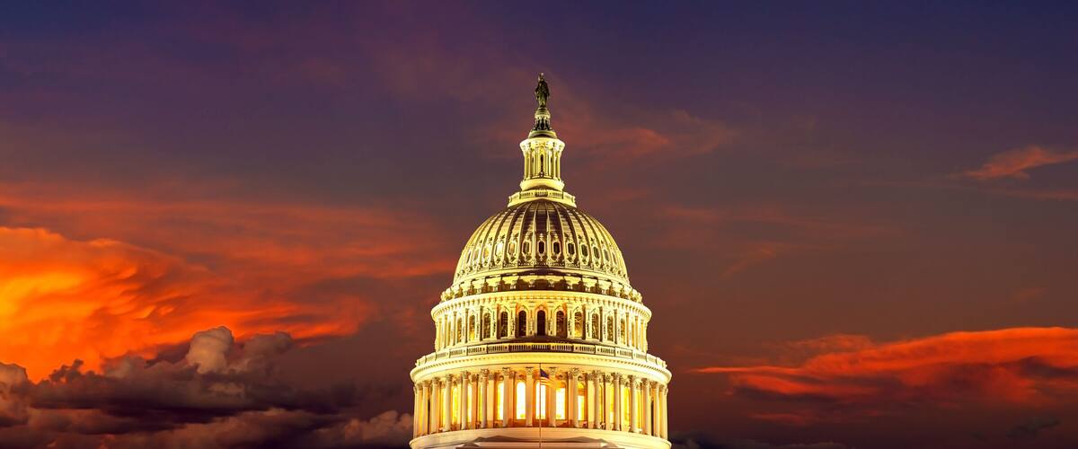 The United States Capitol building at sunset with a dramatic sky.