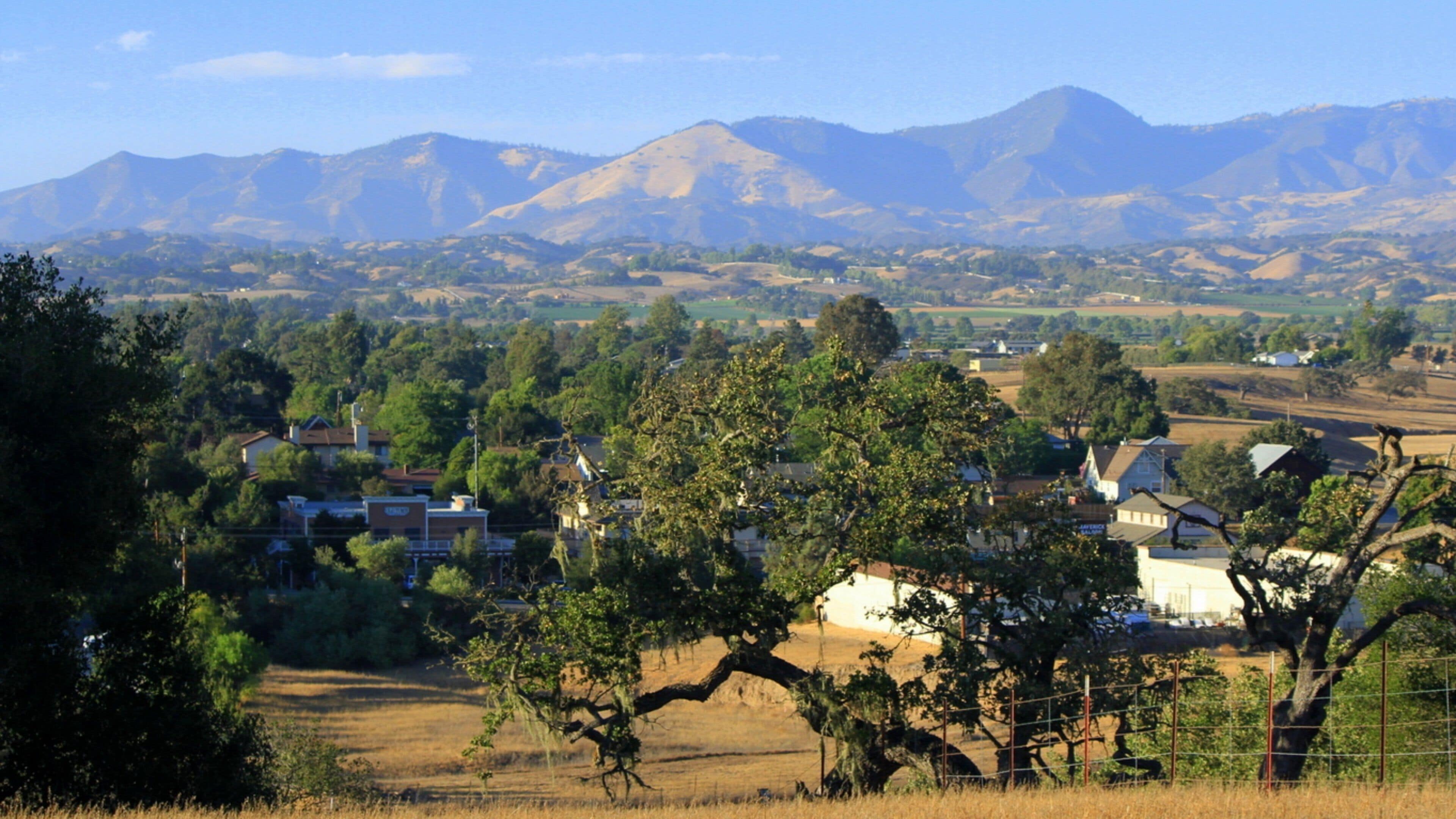Santa Ynez Valley which includes tranquil scenes, mountains and a small town or village