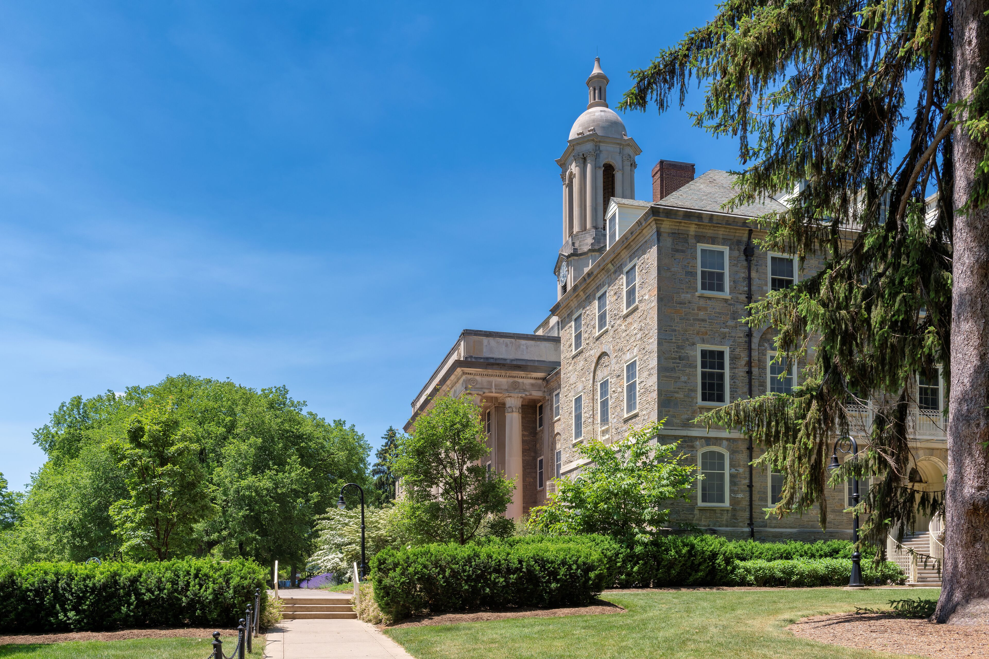 The Old Main building on the campus of Penn State University in spring sunny day, State College, Pennsylvania.