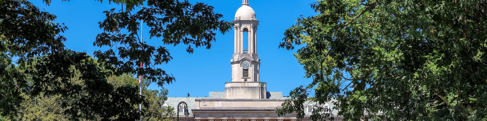The Old Main building on the campus of Penn State University in sunny morning, University Park, State College, Pennsylvania.