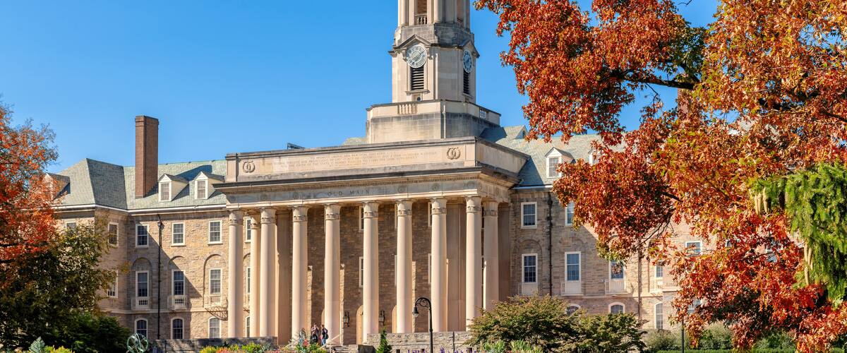 A historic building with a prominent clock tower, columns, and a dome.