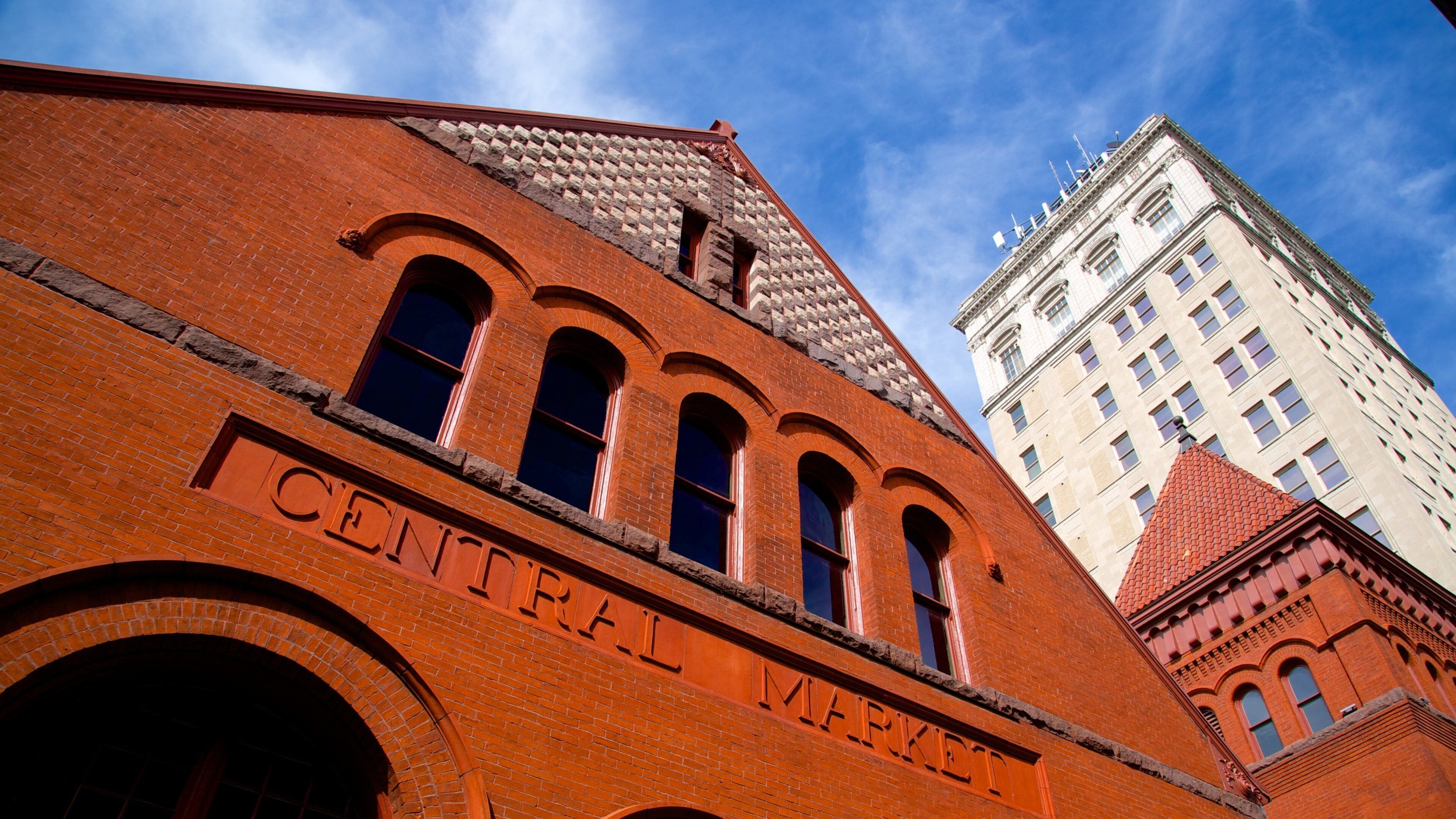 A red brick building with arched windows and the words "CENTRAL MARKET" on its facade.
