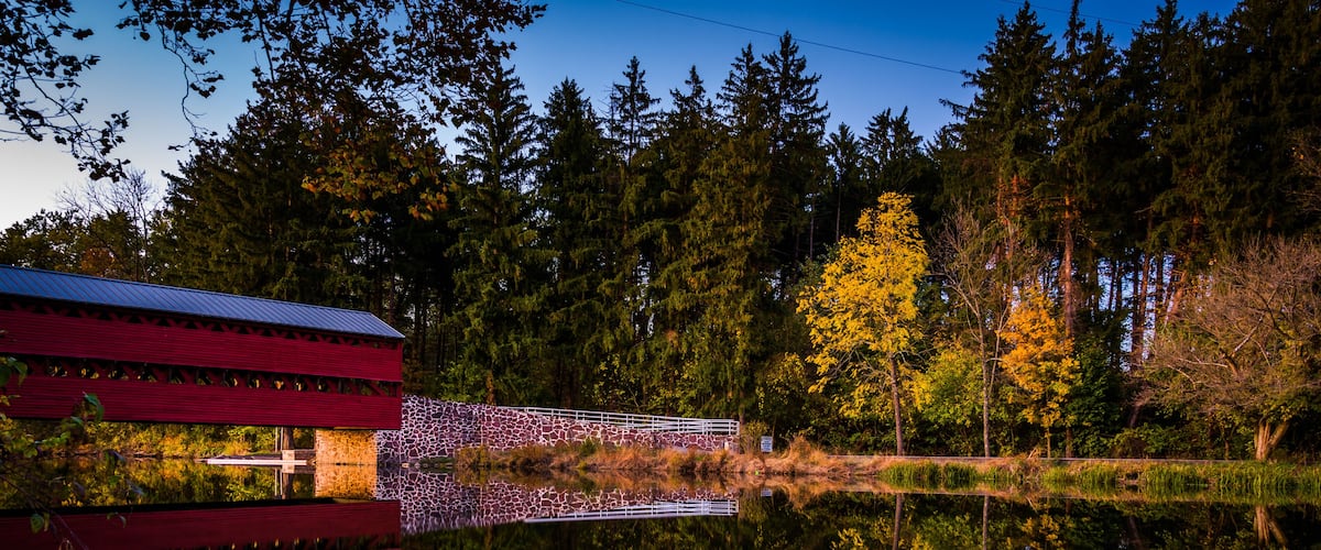Sach's Covered Bridge reflecting in Marsh Creek at twilight, nea