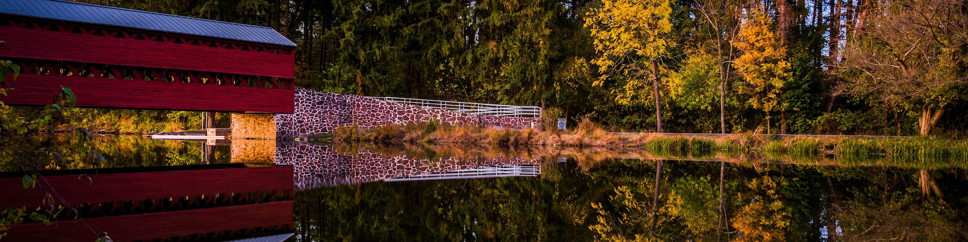 Sach's Covered Bridge reflecting in Marsh Creek at twilight, nea
