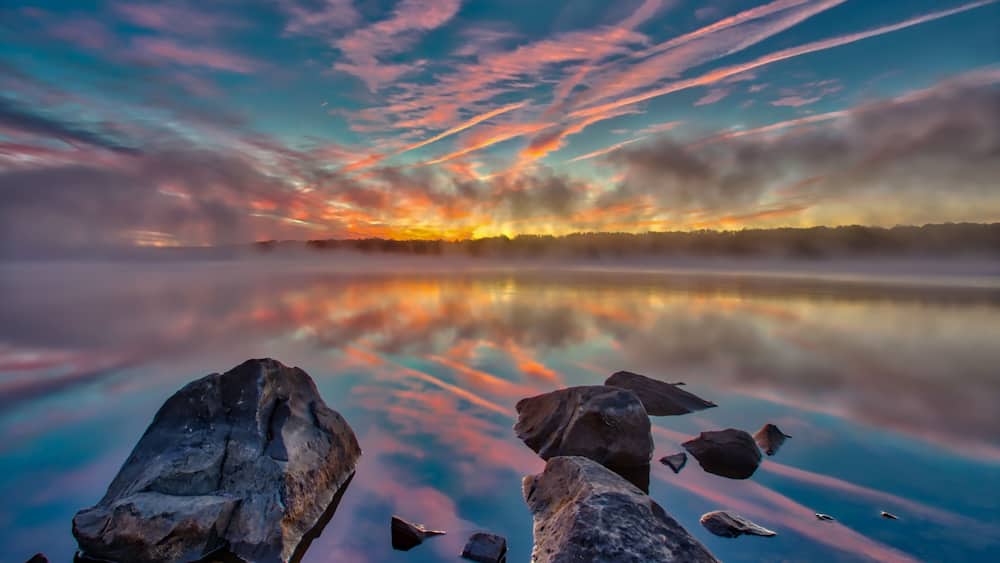 Foggy pre-sunrise skies over the lake in Nockamixon State Park located in Bucks County Pennsylvania.