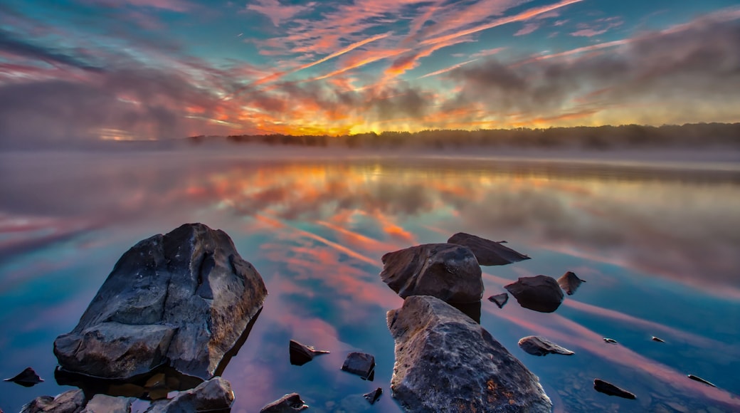 Foggy pre-sunrise skies over the lake in Nockamixon State Park located in Bucks County Pennsylvania.
