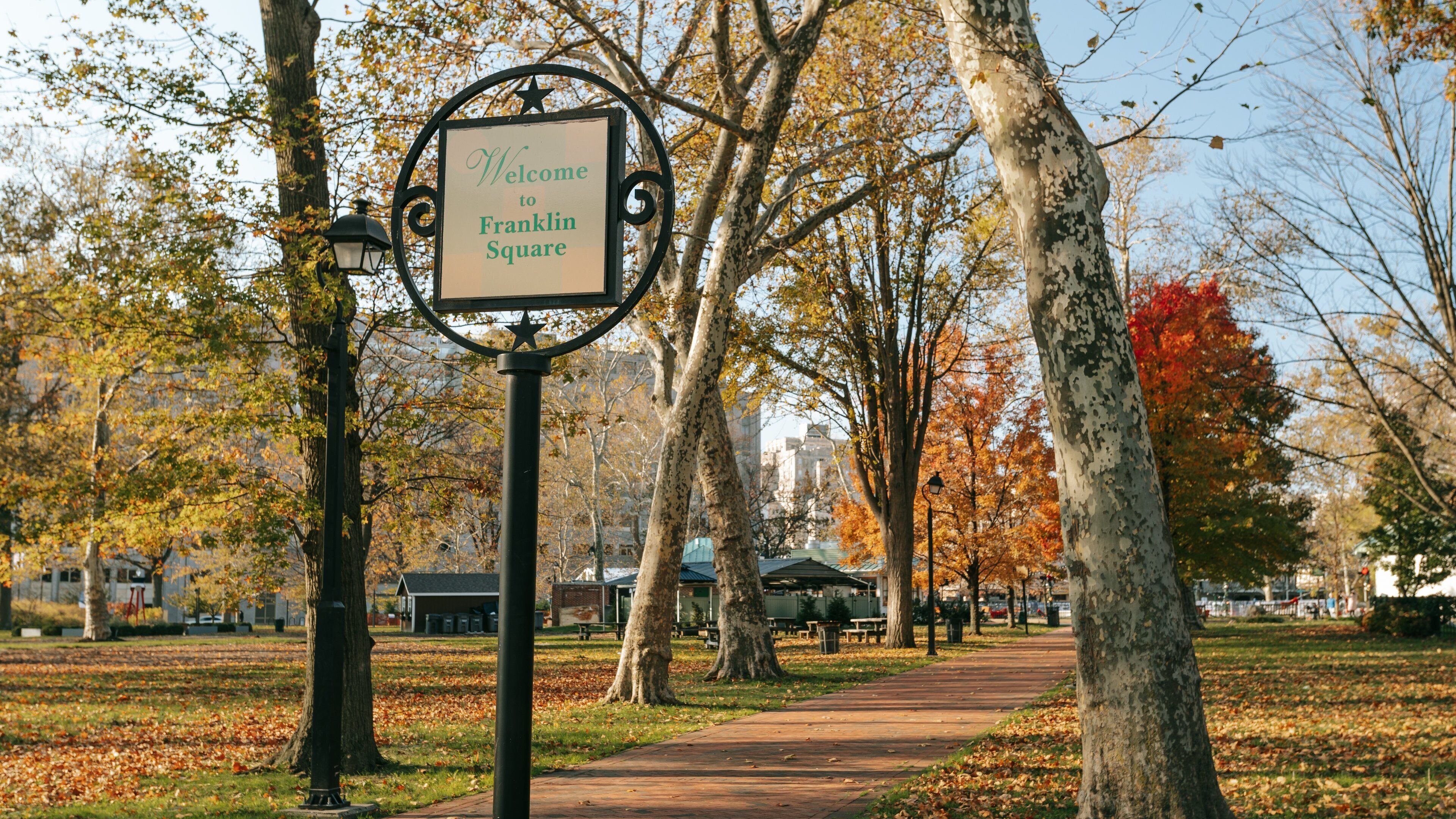 Center City showing signage, fall colors and a garden