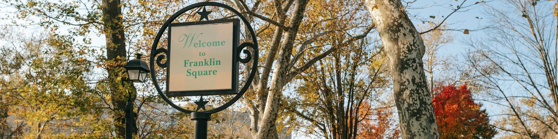 Center City showing signage, fall colors and a garden