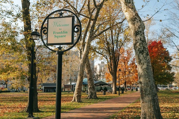 Center City showing signage, fall colors and a garden