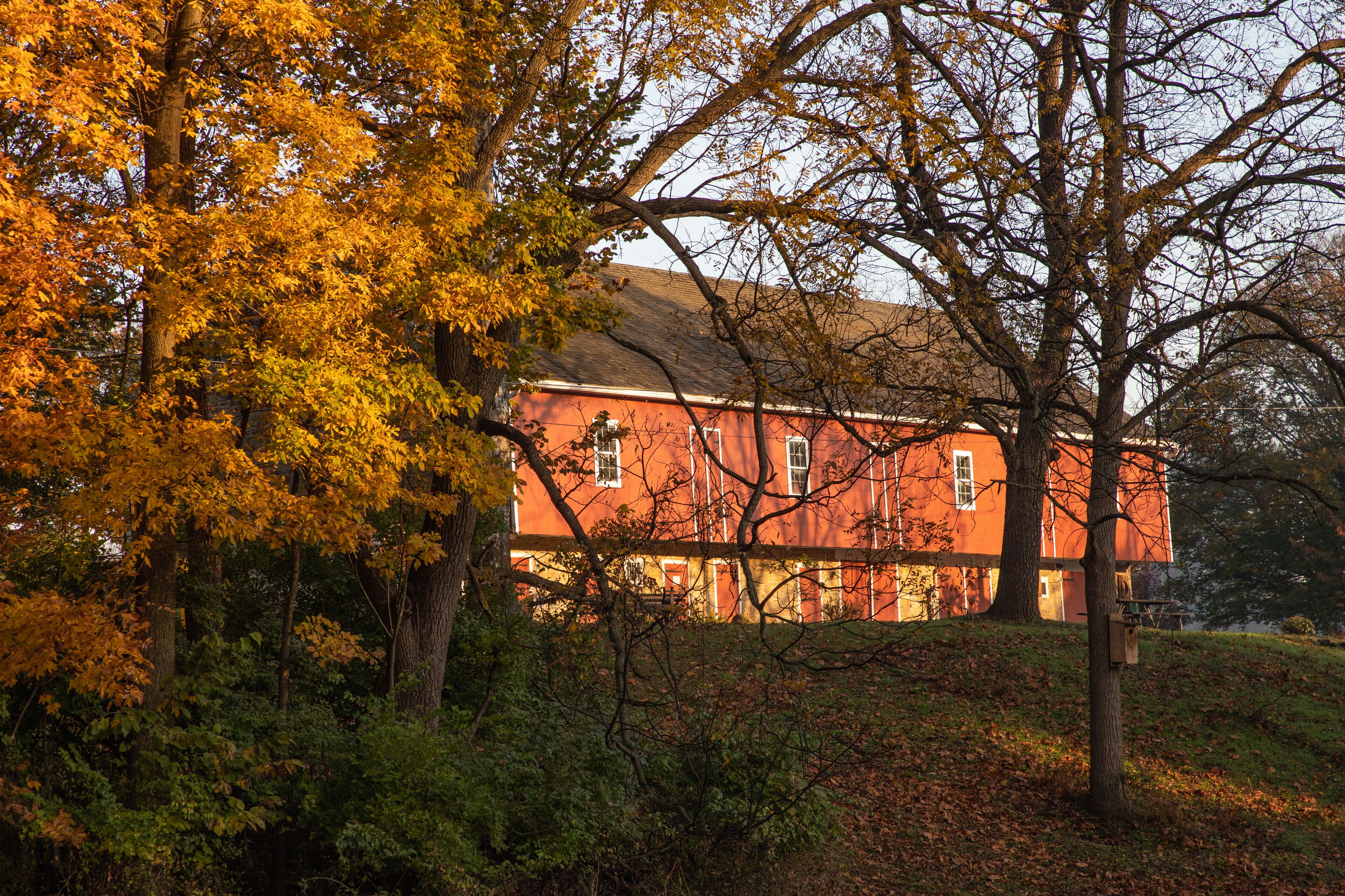 Dawn reflects on a red barn in a Pennsylvania park
