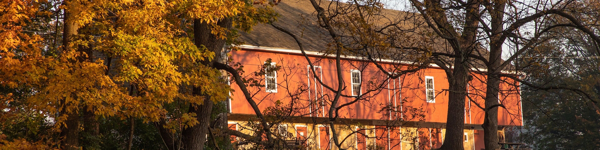 Dawn reflects on a red barn in a Pennsylvania park