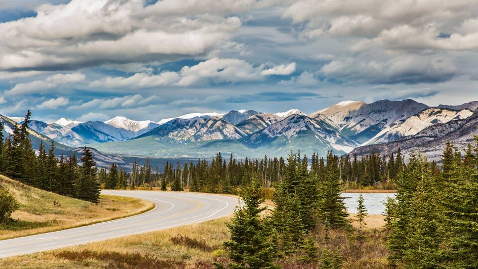 The road to distant snow-capped mountains