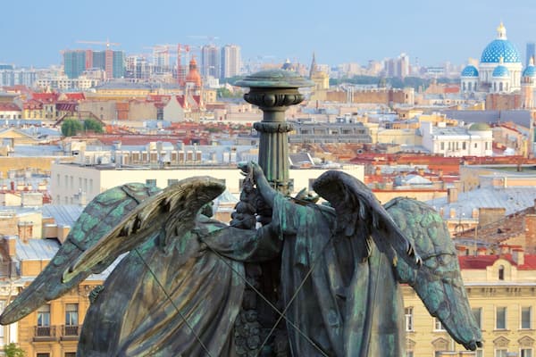 St. Isaac\'s Cathedral featuring a statue or sculpture and a city