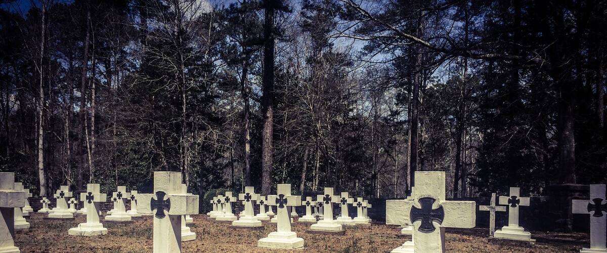 Final resting place for Brother Joseph, who created the art that is known as Ave Maria Grotto.This is a cemetery of only monks in residence at St. Bernard Abbey. 
Ave Maria Grotto, in Cullman, Alabama, is a landscaped, 4-acre park in an old quarry on the grounds of St. Bernard Abbey, providing a garden setting for 125 miniature reproductions of some of the most famous religious structures of the world. It was added to the Alabama Register of Landmarks and Heritage on February 24, 1976, and to the National Register of Historic Places on January 19, 1984. 
The stone and concrete models are the work of Brother Joseph Zoettl, a Benedictine monk of St. Bernard's Abbey, who devoted some 50 years to the project, the last three decades (1932 to 1961) almost without interruption. They incorporate discarded building supplies, bricks, marbles, tiles, pipes, sea shells, marbles, plastic animals, costume jewellery, toilet bowl floats and cold cream jars.
Born in 1878 in the Kingdom of Bavaria, Brother Joseph was maimed in an accident that left him slightly hunched due to cervical kyphosis. He immigrated to the United States as a teenager, settling in northern Alabama. Soon afterward he began studying at the newly founded Benedictine monastery of St. Bernard, where he took his vows in 1897. Br. Joseph was not allowed to be ordained as a priest, due to the rule of the period that stated any man with a distracting disability could not be ordained a priest. He ran the monastery’s power plant and was, even by a monk's standards, a withdrawn, quiet man. Brother Joseph rarely left Alabama, where he died in 1961.