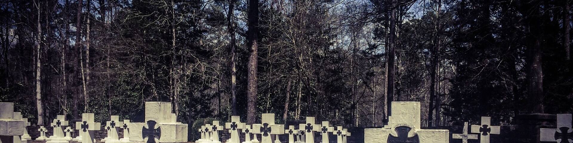 Final resting place for Brother Joseph, who created the art that is known as Ave Maria Grotto.This is a cemetery of only monks in residence at St. Bernard Abbey.
Ave Maria Grotto, in Cullman, Alabama, is a landscaped, 4-acre park in an old quarry on the grounds of St. Bernard Abbey, providing a garden setting for 125 miniature reproductions of some of the most famous religious structures of the world. It was added to the Alabama Register of Landmarks and Heritage on February 24, 1976, and to the National Register of Historic Places on January 19, 1984.
The stone and concrete models are the work of Brother Joseph Zoettl, a Benedictine monk of St. Bernard's Abbey, who devoted some 50 years to the project, the last three decades (1932 to 1961) almost without interruption. They incorporate discarded building supplies, bricks, marbles, tiles, pipes, sea shells, marbles, plastic animals, costume jewellery, toilet bowl floats and cold cream jars.
Born in 1878 in the Kingdom of Bavaria, Brother Joseph was maimed in an accident that left him slightly hunched due to cervical kyphosis. He immigrated to the United States as a teenager, settling in northern Alabama. Soon afterward he began studying at the newly founded Benedictine monastery of St. Bernard, where he took his vows in 1897. Br. Joseph was not allowed to be ordained as a priest, due to the rule of the period that stated any man with a distracting disability could not be ordained a priest. He ran the monastery’s power plant and was, even by a monk's standards, a withdrawn, quiet man. Brother Joseph rarely left Alabama, where he died in 1961.