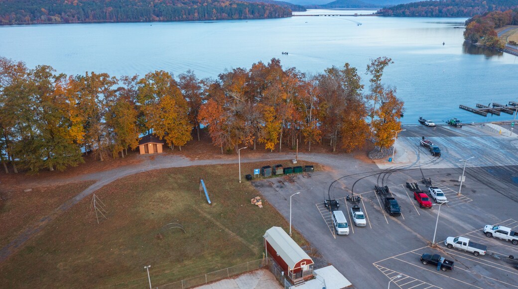 Aerial view of a bass tournament starting at a boat ramp marina in Scottsboro Alabama with boats on Guntersville Lake fishing on a colorful autumn day.