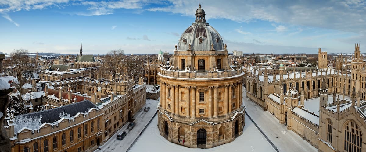 A historic building with a prominent dome, surrounded by snow-covered architecture.