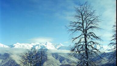 A snow-covered mountain range with clear skies.