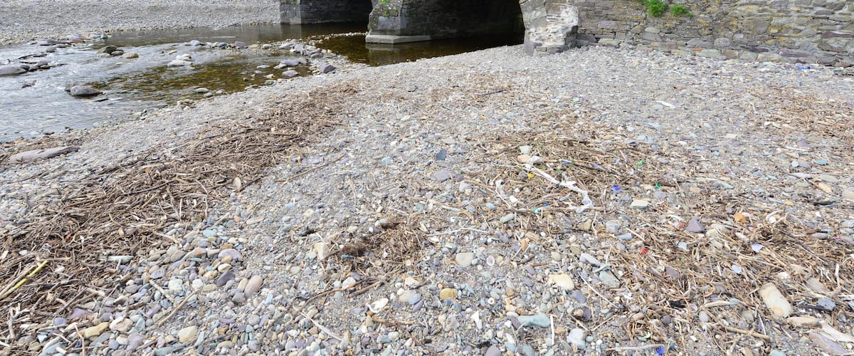 A stone bridge over a rocky stream.