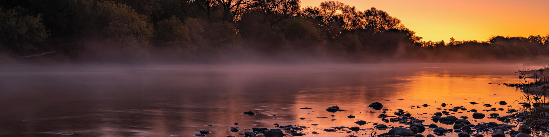 Early morning on the Grand River.  Fall is a great time of year in Ontario because not only are the leaves changing colours, but there is usually a mist on the water early in the morning.
When I woke up and started driving to this spot close to #MyBackyard I wasn't optimistic because there were no clouds in the sky for the sun to light up.  I was pleasantly surprised when the horizon started to turn orange and pink just before the sun rose.
Cambridge, Kitchener and Waterloo are all great cities for photography as there are many trails that run along the Grand River.
