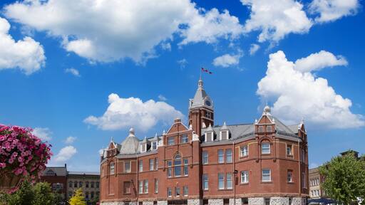 Red brick city hall with a clock tower in the scenic historic center in Stratford, Ontario.