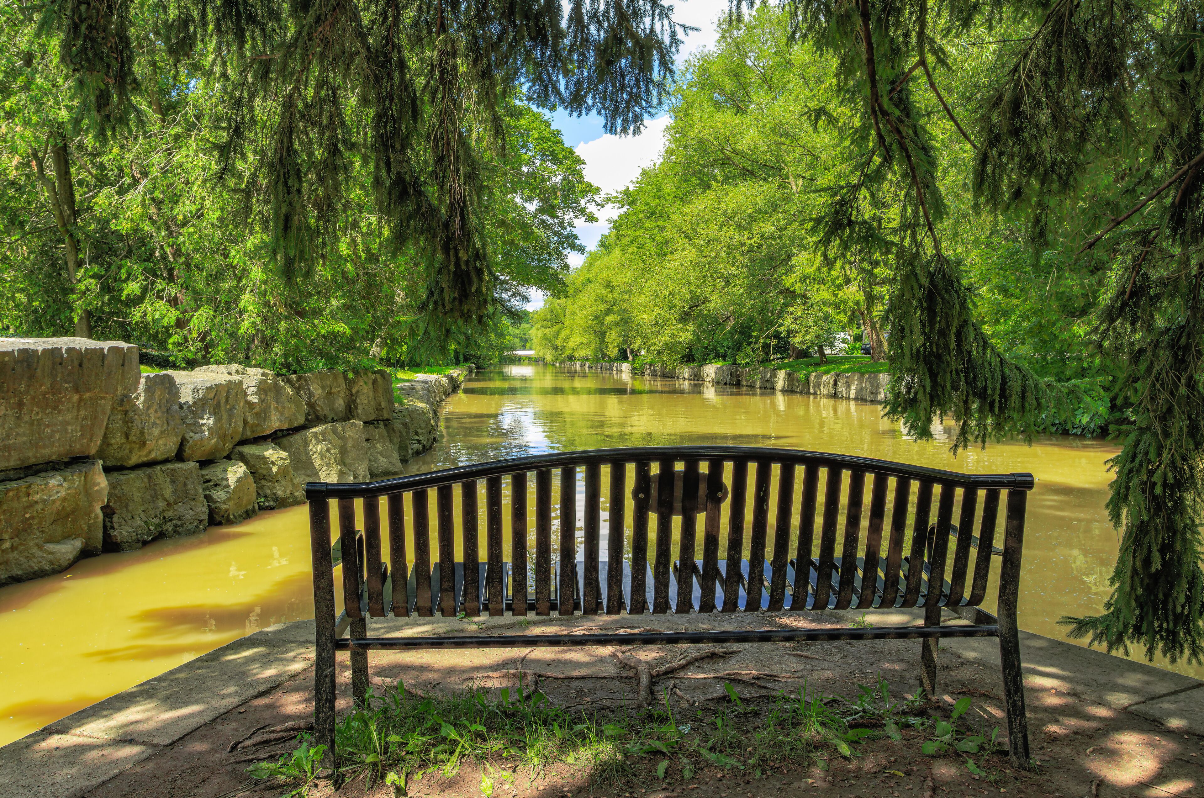 Bench with a view to Avon river in Shakespearean gardens, Stratford, Canada.