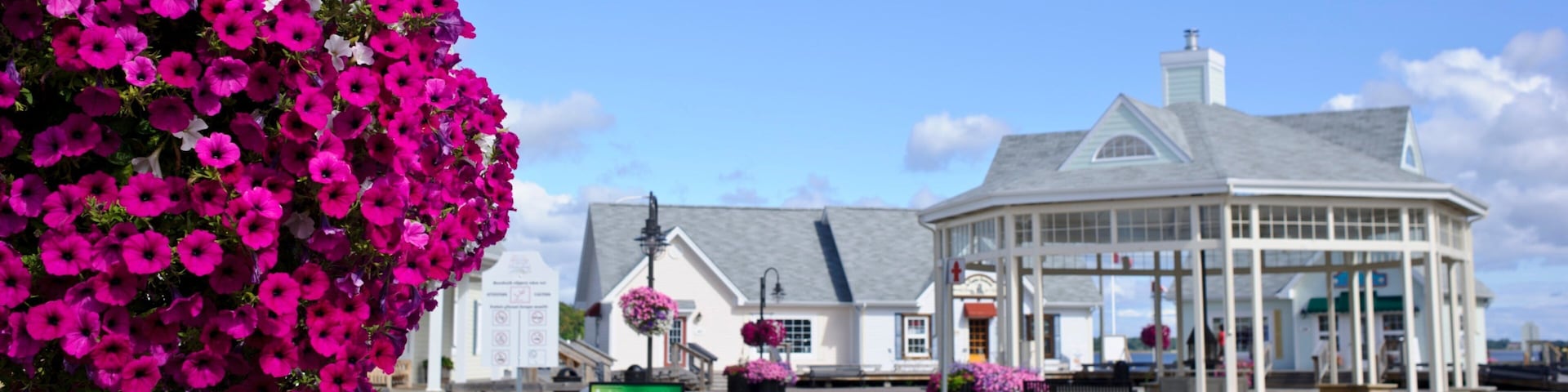 A gazebo, a white building, and a flower arrangement.